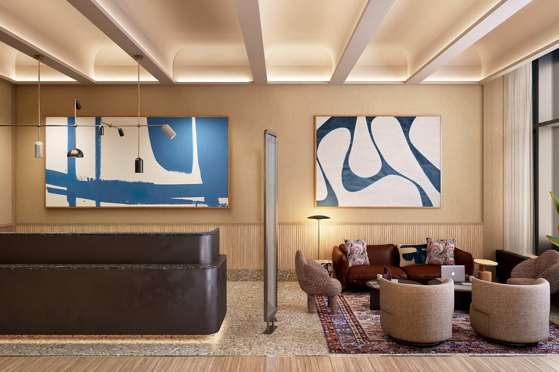 Modern hotel lobby with a dark front desk, abstract blue and white artwork on beige walls, a seating area with brown sofas, round chairs, a rug, and large windows letting in natural light.
