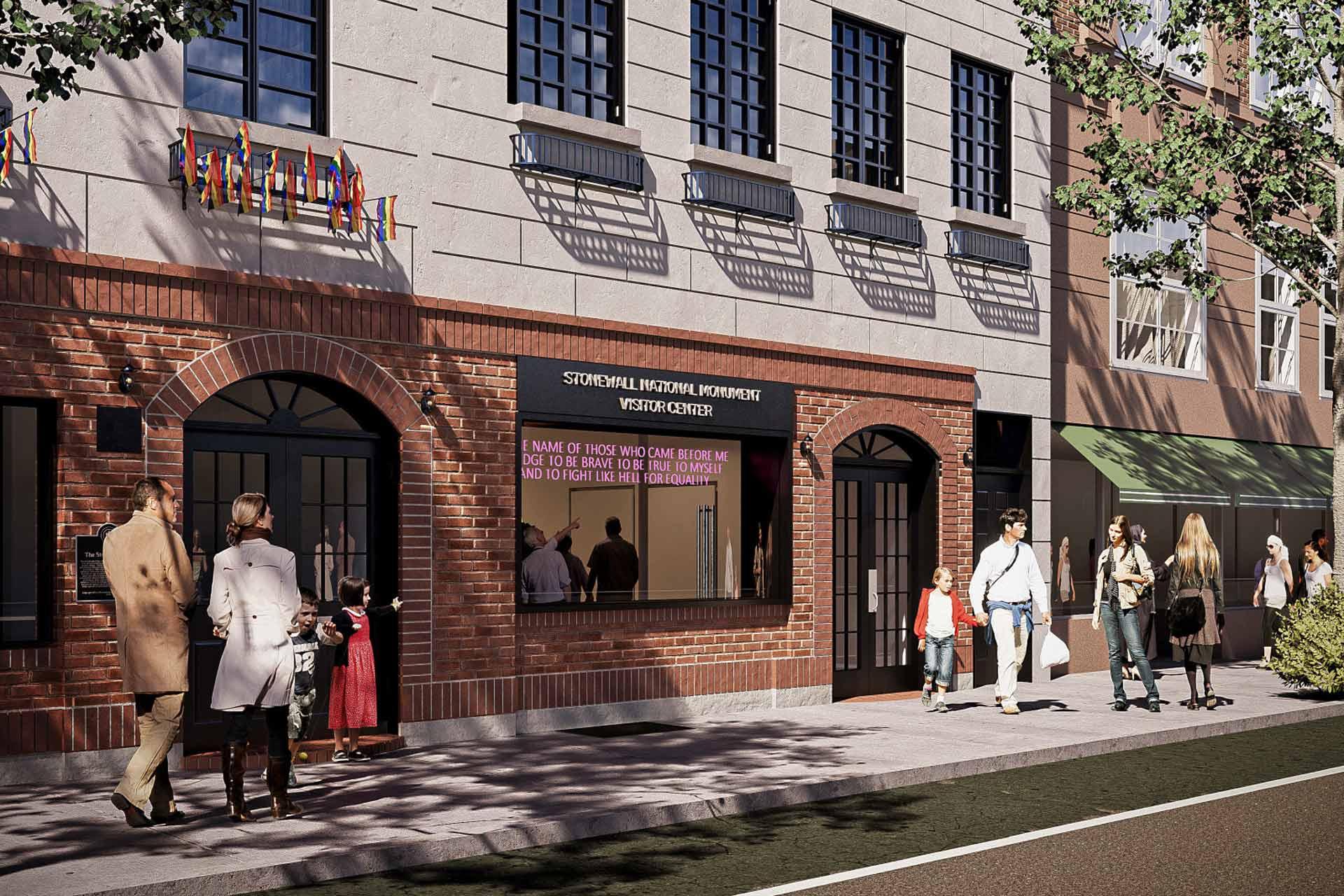 Street view of a municipal building with red brick and stone facade. People walk by, including adults and a child. Windows display both flags and digital text. Sunlight casts shadows from trees onto the sidewalk.