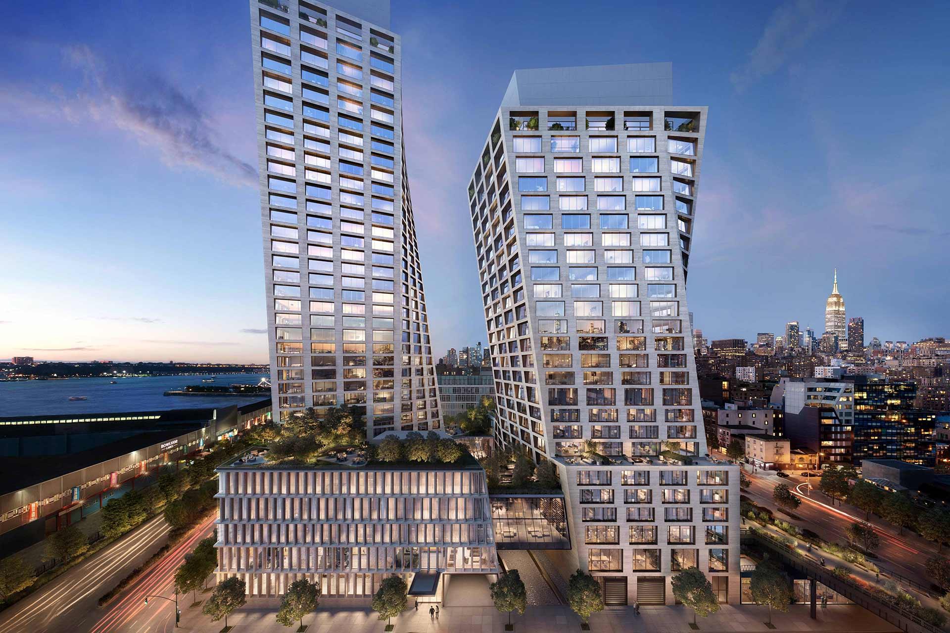 Twin modern high-rise buildings with geometric designs and large windows, set against a cityscape at dusk. The Empire State Building is visible in the background and busy streets surround the buildings.