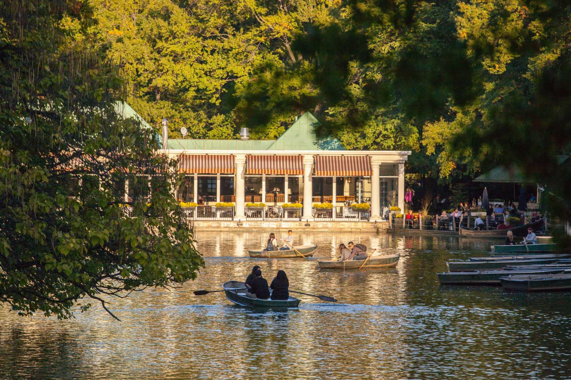 People boating in pond outside the Central Park Boathouse in NYC